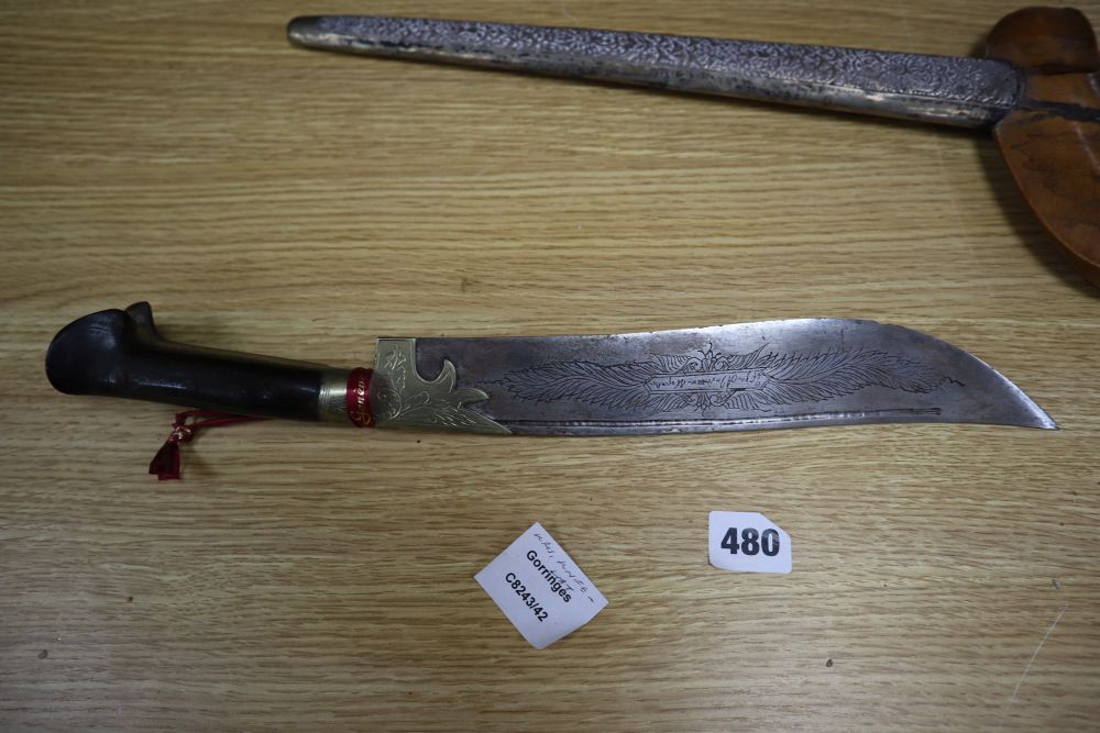 A 19th century Javanese kris, with 14 inch blade, two other edged weapons and a ceremonial head-dress